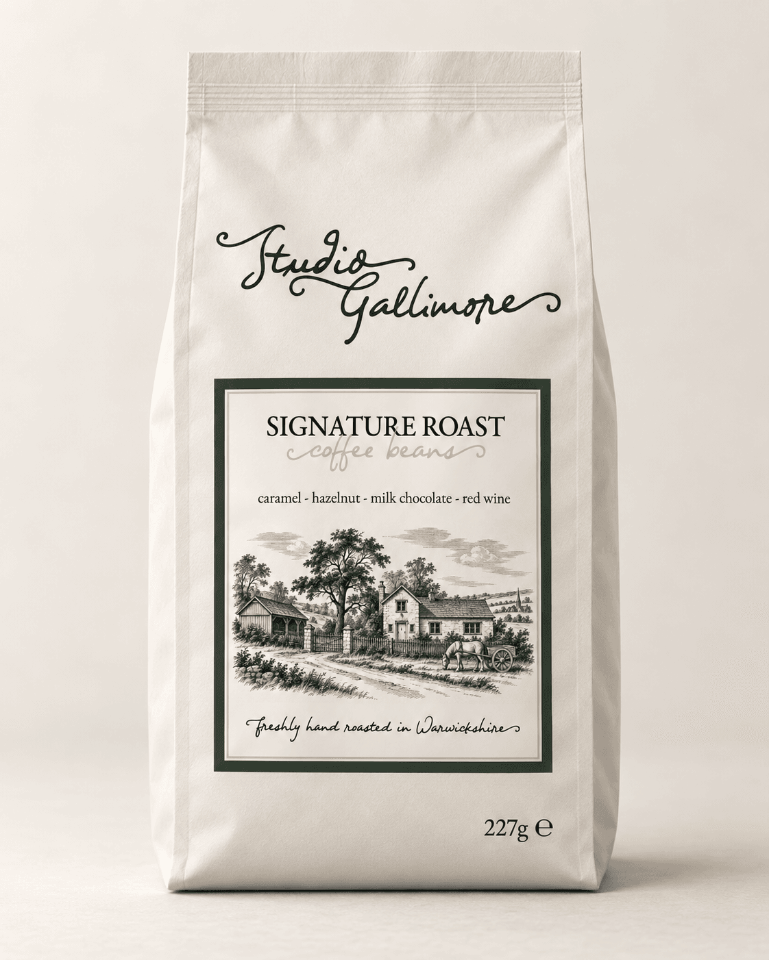 Studio Gallimore Signature Roast coffee beans, 227g bag, cream with a deep green label and an engraved cottage scene.