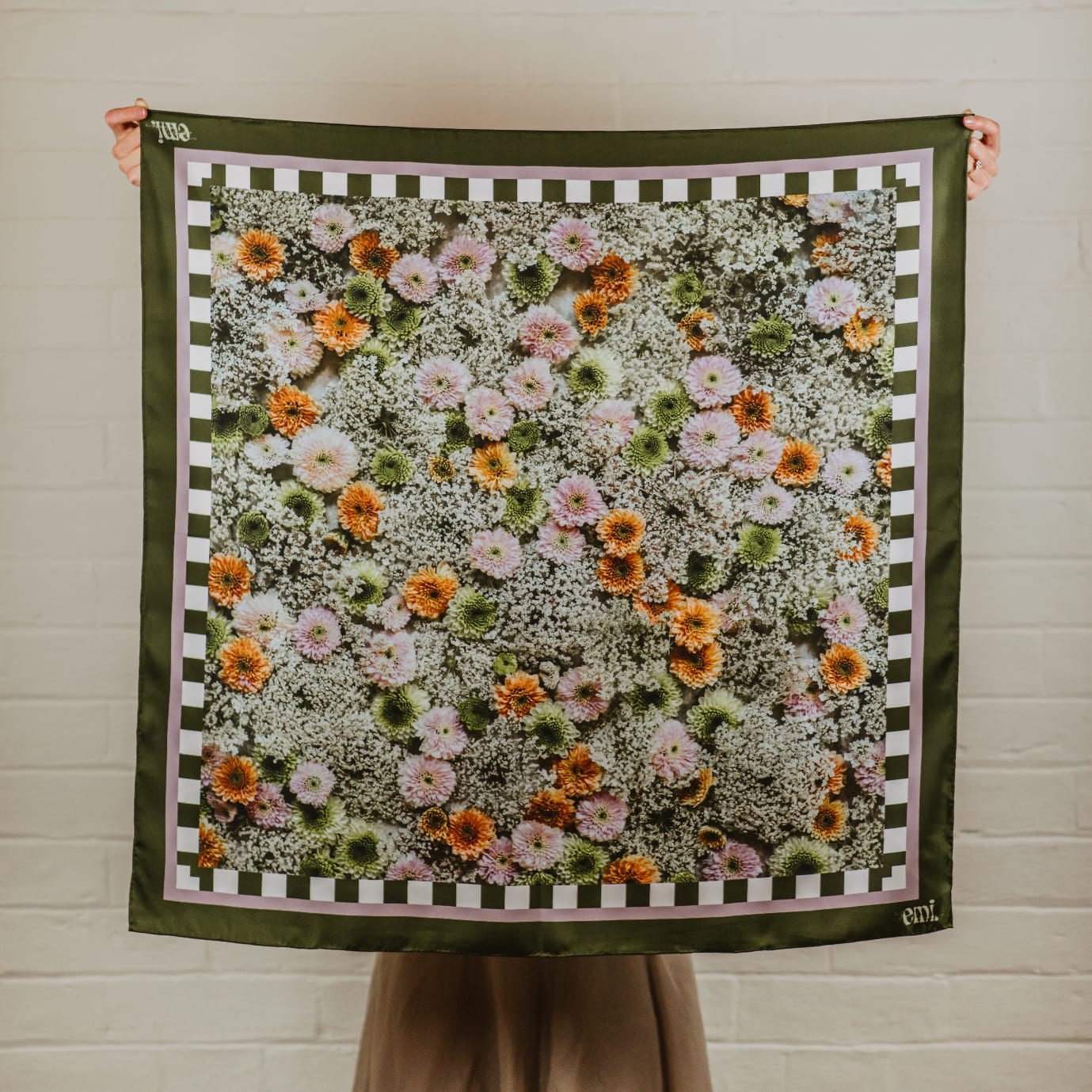 Bloom, a silk scarf printed with orange, pink and green chrysanthemums among Queen Anne's lace, inside a deep green border with a green and white check.